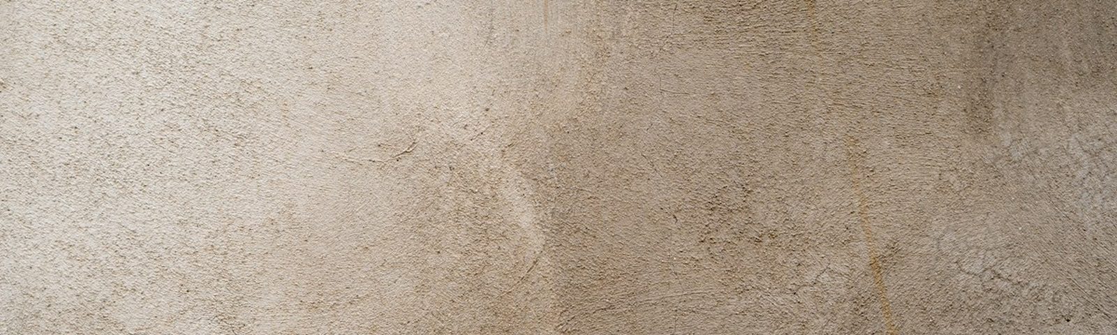 A warm plaster surface in raking daylight.