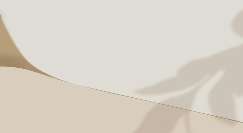 A soft beige curve under a leaf shadow.