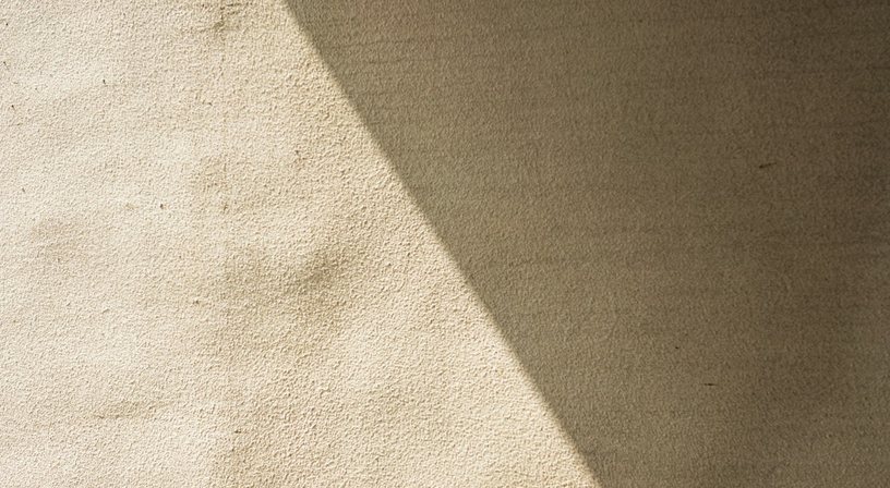 Daylight falling across a warm wall.